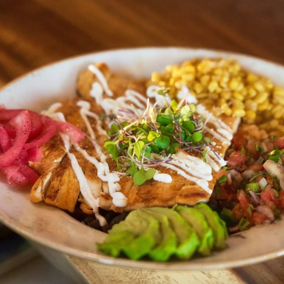 Mezcal's grilled chicken dish with corn, avocado, pickled onions, and pico de gallo.